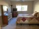 Bedroom with a queen bed, dresser, and TV at 10840 E Keats Ave, Mesa, AZ 85209