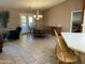 Dining area with wooden table and chairs, near the kitchen at 10840 E Keats Ave, Mesa, AZ 85209