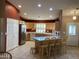 Bright kitchen with light wood cabinets and a breakfast bar at 10840 E Keats Ave, Mesa, AZ 85209