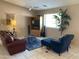 Living room with leather sofa, armchair, and entertainment center at 10840 E Keats Ave, Mesa, AZ 85209