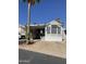 White single-wide manufactured home with covered carport and desert landscaping at 1448 S Zuni --, Apache Junction, AZ 85119
