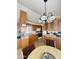 Bright kitchen with wood cabinets, an island, and a chandelier over the dining area at 1448 S Zuni --, Apache Junction, AZ 85119