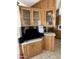 Kitchen features wood cabinets, glass-front upper cabinets, and a built-in entertainment center at 1448 S Zuni --, Apache Junction, AZ 85119