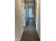 Long hallway with doors to bedrooms and laundry room at 14652 S Avalon Rd, Arizona City, AZ 85123