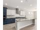 Modern kitchen with blue and white cabinets and granite counters at 15208 S 182Nd Ln, Goodyear, AZ 85338