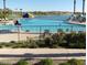 Relaxing pool area with ample seating and lake views at 15208 S 182Nd Ln, Goodyear, AZ 85338