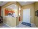 Kitchen with orange cabinets and a breakfast bar at 16422 W La Posada Ln, Surprise, AZ 85374