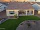 Covered patio, artificial turf, and desert landscaping at 16541 W Edgemont Ave, Goodyear, AZ 85395