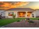 Home with covered patio, artificial turf, and fire pit at 16541 W Edgemont Ave, Goodyear, AZ 85395