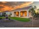 Covered patio with fireplace and artificial turf at 16541 W Edgemont Ave, Goodyear, AZ 85395