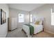 Charming bedroom with white dresser and green blanket at 16541 W Edgemont Ave, Goodyear, AZ 85395