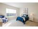 Comfortable bedroom with plush carpeting and large window at 16541 W Edgemont Ave, Goodyear, AZ 85395