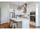 Bright kitchen featuring white cabinets, stainless steel appliances, and an island with seating at 16541 W Edgemont Ave, Goodyear, AZ 85395