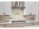 Close-up of a kitchen's gas cooktop and stylish backsplash at 16541 W Edgemont Ave, Goodyear, AZ 85395