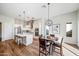 Open kitchen and dining area with modern fixtures and hardwood floors at 16541 W Edgemont Ave, Goodyear, AZ 85395