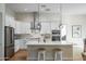 Modern kitchen with white cabinets, stainless steel appliances, and a large island at 16541 W Edgemont Ave, Goodyear, AZ 85395