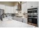 Modern kitchen with white cabinets, stainless steel appliances, and a large island at 16541 W Edgemont Ave, Goodyear, AZ 85395
