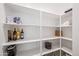 Well-organized pantry with ample shelving for storage at 16541 W Edgemont Ave, Goodyear, AZ 85395
