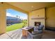 Covered patio with fireplace and seating area at 16541 W Edgemont Ave, Goodyear, AZ 85395