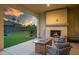 Relaxing covered patio with fireplace and fire pit at 16541 W Edgemont Ave, Goodyear, AZ 85395