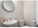 Clean powder room with pedestal sink and toilet at 16541 W Edgemont Ave, Goodyear, AZ 85395