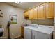 Laundry room with washer, dryer, and ample cabinet space at 18411 E Tranquilo Way, Rio Verde, AZ 85263