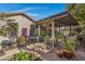 Landscaped backyard with a pergola, brick pathway, and outdoor kitchen at 1971 E Yellowstone Pl, Chandler, AZ 85249