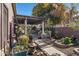 Landscaped backyard with a pergola, brick pathway, and various plants at 1971 E Yellowstone Pl, Chandler, AZ 85249