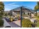 Landscaped backyard with a pergola, brick patio, and colorful planters at 1971 E Yellowstone Pl, Chandler, AZ 85249
