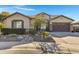 One-story house with a brown door, and landscaped yard at 1971 E Yellowstone Pl, Chandler, AZ 85249