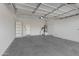 Garage with a high ceiling, concrete floor, and built-in shelving at 1971 E Yellowstone Pl, Chandler, AZ 85249