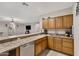 Kitchen with wood cabinets, granite countertops, and stainless steel dishwasher at 1971 E Yellowstone Pl, Chandler, AZ 85249