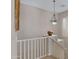 Upstairs hallway with white railing and elegant light fixture at 1971 E Yellowstone Pl, Chandler, AZ 85249