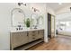 Elegant bathroom with dual sinks, a walk-in closet, and bedroom view at 20321 N 106Th Ave, Peoria, AZ 85382