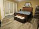 Main bedroom with wood flooring and access to a private patio at 2121 W Union Hills Dr # 115, Phoenix, AZ 85027
