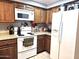 Well-equipped kitchen featuring a microwave, stove, and refrigerator at 2121 W Union Hills Dr # 115, Phoenix, AZ 85027