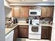 Functional kitchen with white appliances, wood cabinets, and plenty of counter space at 2121 W Union Hills Dr # 115, Phoenix, AZ 85027