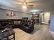 Inviting living room featuring a large, comfortable leather sectional and an open floor plan at 2121 W Union Hills Dr # 115, Phoenix, AZ 85027