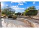 Landscaped backyard with mature trees and a paved patio area at 21364 N Redington Point Dr, Surprise, AZ 85387