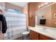 Clean bathroom with shower/tub combo and wood vanity at 21364 N Redington Point Dr, Surprise, AZ 85387