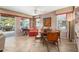 Bright dining area with a round table and leather chairs, adjacent to the living room at 21364 N Redington Point Dr, Surprise, AZ 85387