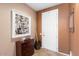 Bright entryway with a large framed painting and wooden cabinet at 21364 N Redington Point Dr, Surprise, AZ 85387