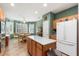 Kitchen with island, breakfast nook, and white refrigerator at 21364 N Redington Point Dr, Surprise, AZ 85387