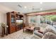Spacious living room with large sectional sofa and entertainment center at 21364 N Redington Point Dr, Surprise, AZ 85387