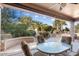 Covered patio with seating area and view of trees at 21364 N Redington Point Dr, Surprise, AZ 85387