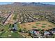 Aerial view showcasing community near golf course and mountains at 23335 N Country Club Trl, Scottsdale, AZ 85255