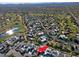 An aerial shot highlighting a house in a neighborhood near a golf course and lake at 23335 N Country Club Trl, Scottsdale, AZ 85255