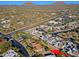 Aerial view of a house in a community by a main road with mountain views at 23335 N Country Club Trl, Scottsdale, AZ 85255