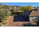An aerial view showcasing the property's garage and landscaping at 23335 N Country Club Trl, Scottsdale, AZ 85255