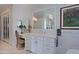 Elegant bathroom with a double vanity, large mirror, and herringbone tile floor at 23335 N Country Club Trl, Scottsdale, AZ 85255
